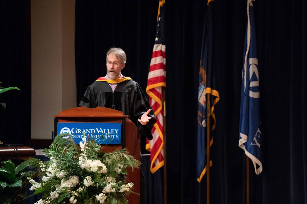 Faculty Member gives a speech on stage.